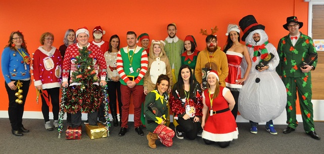 Health-on-Line staff show off their hideous Christmas jumpers for charity